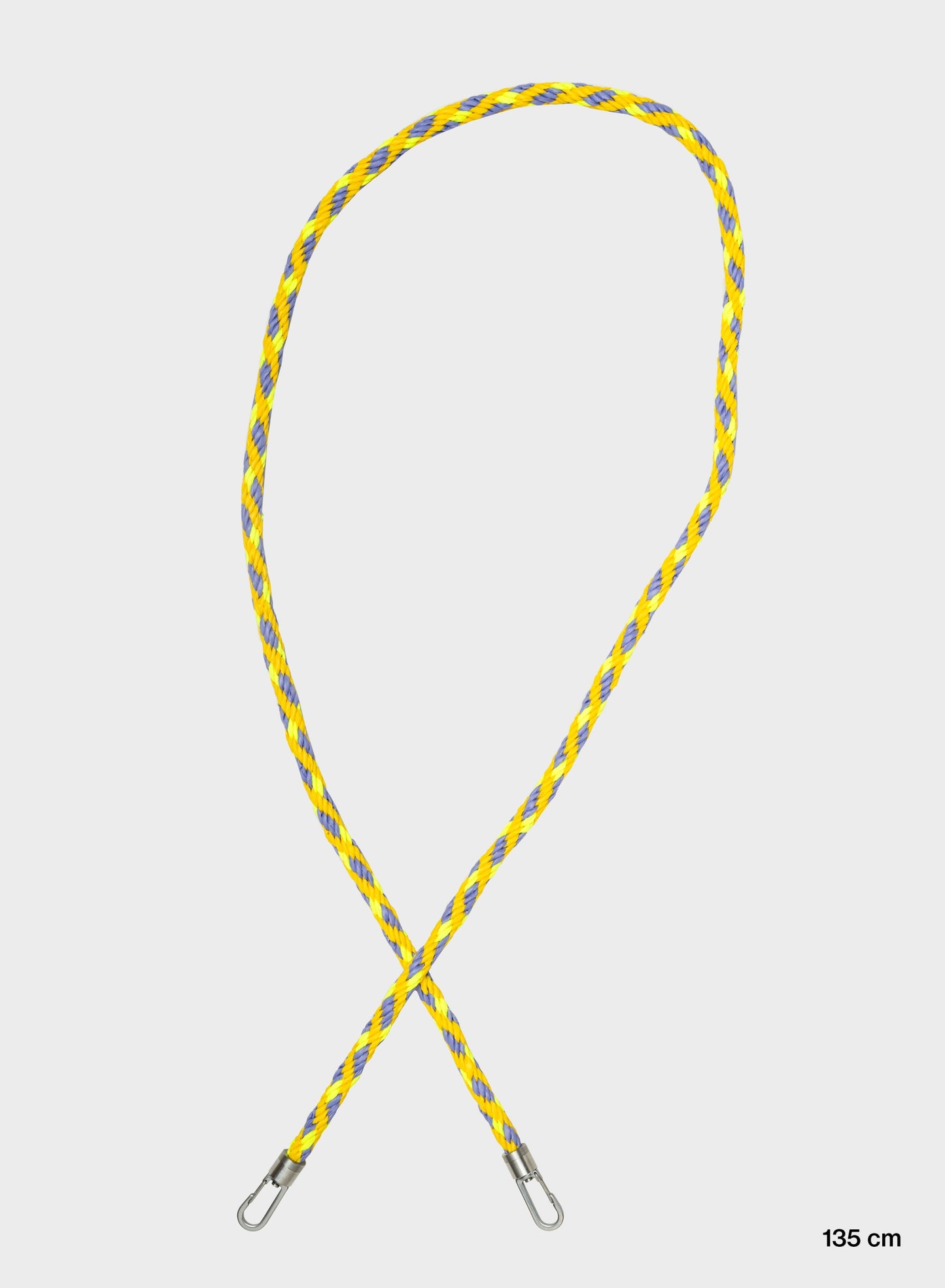 he New Kumihimo Strap Treble & Fluo Yellow features intricate Japanese inspired braiding, with a blue base colour accented by vibrant yellow and darker yellow stripes. Measuring 135 cm in length, this strap is fitted with metal clips at both ends and is shown looped against a white background.