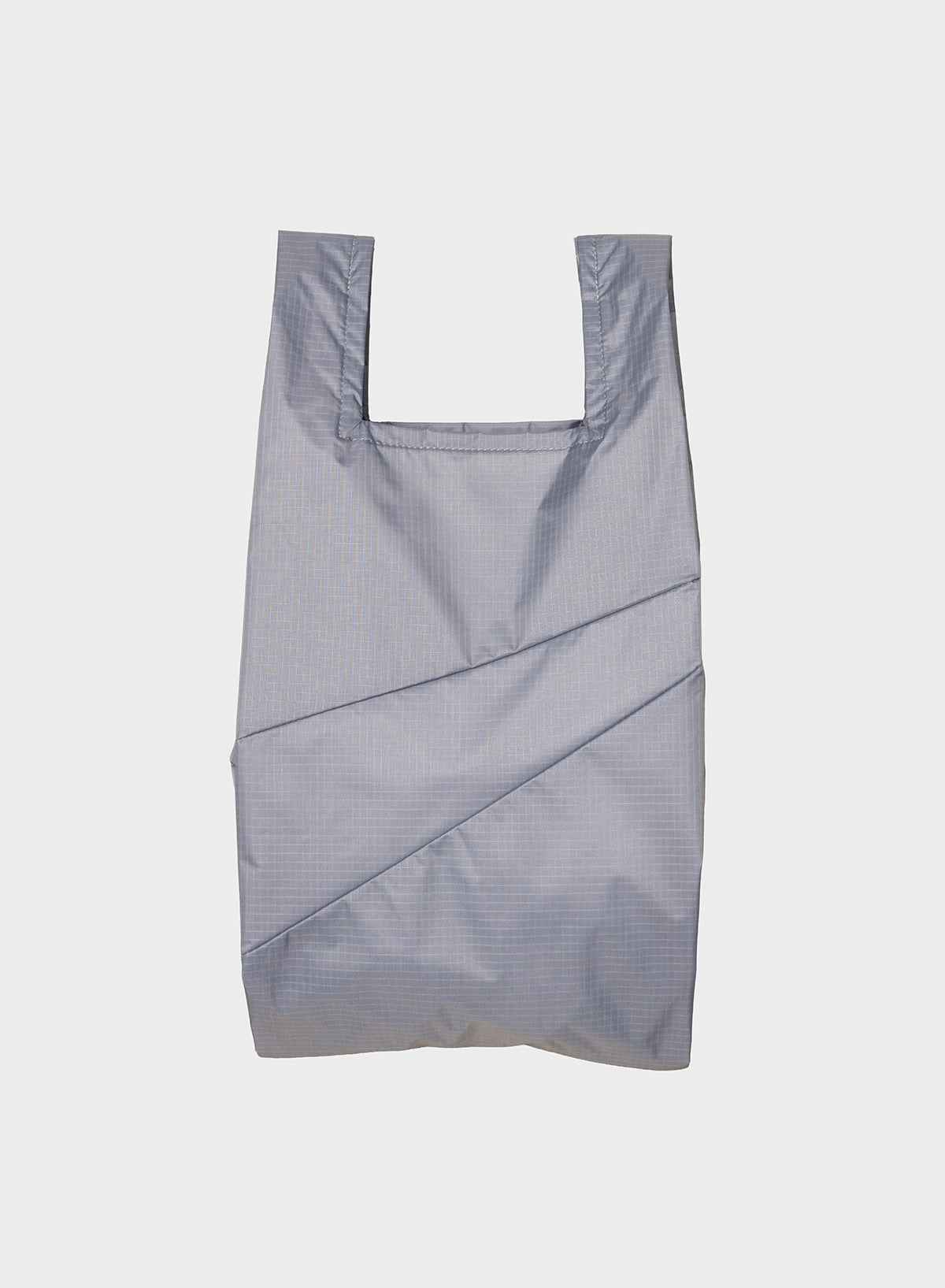 A light gray reusable plastic bag with a subtle grid pattern and diagonal stitched details, shown against a plain light gray background.