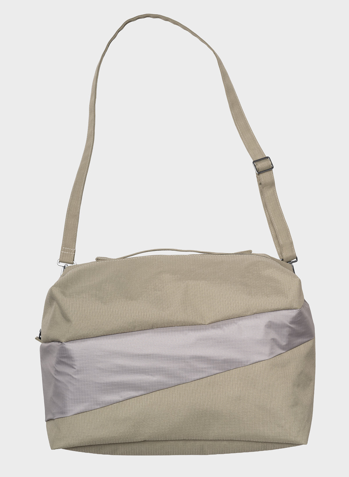 A light beige nylon shoulder bag with a diagonal metallic silver panel on the front and a matching beige adjustable shoulder strap, shown against a light gray background.